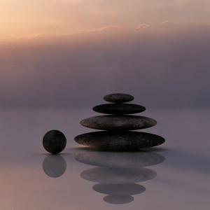 A pile of rocks, perfectly balanced and with a reflection - representing meditation