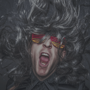 Man with big hair and sunglasses, with lots of enthusiasm