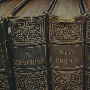Two old books, side by side - one of 'my memories' and the other of family photos